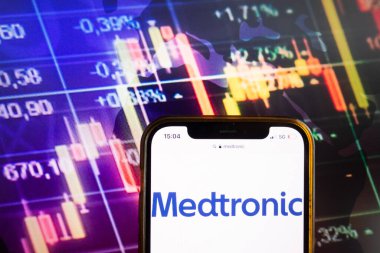 KONSKIE, POLAND - August 07, 2022: Smartphone displaying logo of Medtronic plc on stock exchange diagram background clipart