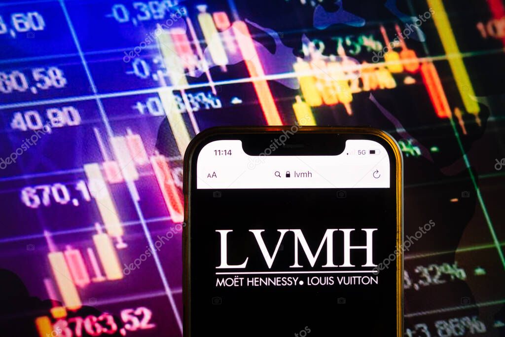 KONSKIE, POLAND - August 07, 2022: Smartphone displaying logo of LVMH Moet Hennessy Louis Vuitton corporation on stock exchange diagram background
