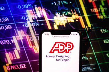 KONSKIE, POLAND - August 09, 2022: Smartphone displaying logo of Automatic Data Processing company on stock exchange diagram background
