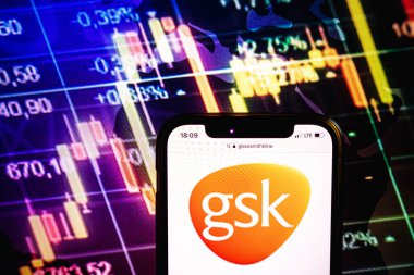 KONSKIE, POLAND - August 09, 2022: Smartphone displaying logo of GlaxoSmithKline company on stock exchange diagram background