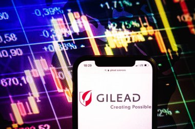 KONSKIE, POLAND - August 09, 2022: Smartphone displaying logo of Gilead Sciences company on stock exchange diagram background