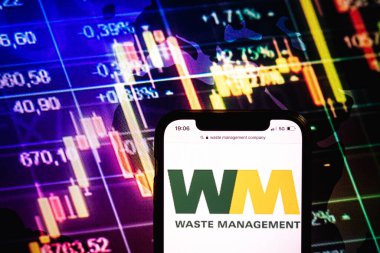 KONSKIE, POLAND - August 09, 2022: Smartphone displaying logo of Waste Management company on stock exchange diagram background