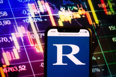 KONSKIE, POLAND - August 10, 2022: Smartphone displaying logo of Compagnie Financiere Richemont company on stock exchange diagram background