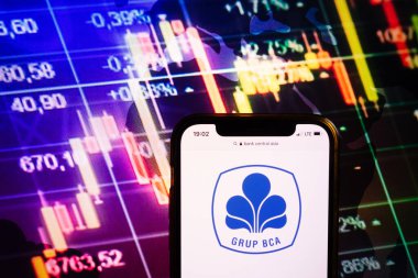 KONSKIE, POLAND - August 10, 2022: Smartphone displaying logo of Bank Central Asia company on stock exchange diagram background