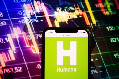 KONSKIE, POLAND - August 10, 2022: Smartphone displaying logo of Humana company on stock exchange diagram background