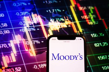 KONSKIE, POLAND - August 10, 2022: Smartphone displaying logo of Moody`s company on stock exchange diagram background