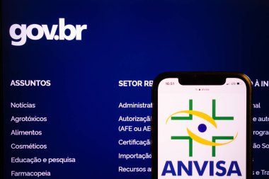 KONSKIE, POLAND - August 21, 2022: Smartphone displaying logo of Agencia Nacional de Vigilancia Sanitaria (ANVISA) on Brazilian government webpage background