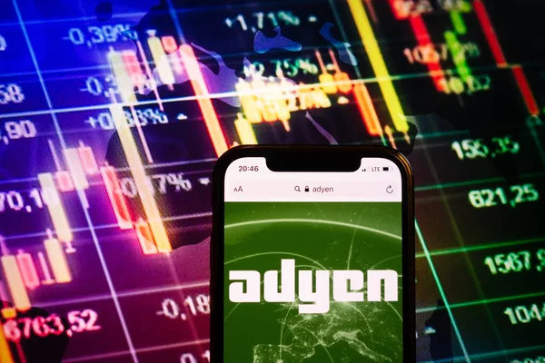 KONSKIE, POLAND - August 10, 2022: Smartphone displaying logo of Adyen company on stock exchange diagram background