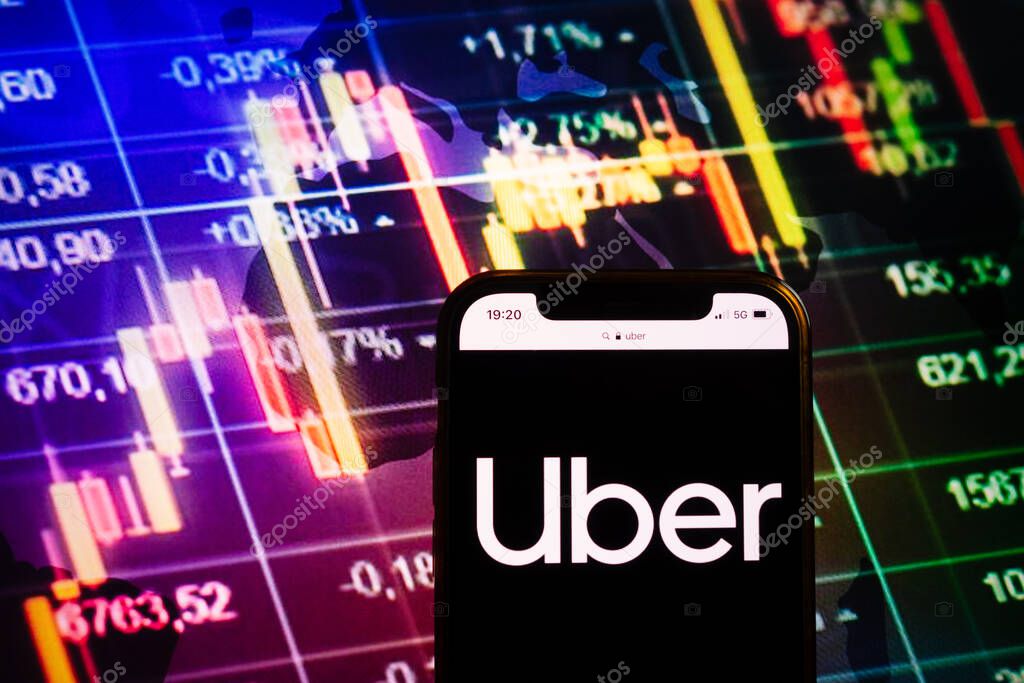 KONSKIE, POLAND - August 10, 2022: Smartphone displaying logo of Uber company on stock exchange diagram background