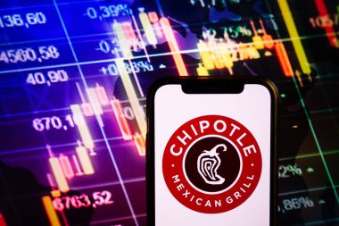 KONSKIE, POLAND - September 04, 2022: Smartphone displaying logo of Chipotle Mexican Grill company on stock exchange diagram background