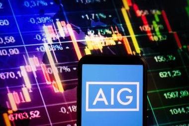 KONSKIE, POLAND - September 04, 2022: Smartphone displaying logo of American International Group (AIG) company on stock exchange diagram background