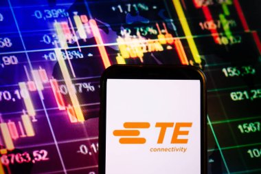 KONSKIE, POLAND - September 04, 2022: Smartphone displaying logo of TE Connectivity company on stock exchange diagram background