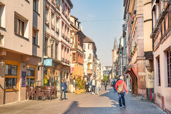 2 of May 2022, Strasbourg, France. Cozy beautiful street in Strasbourg, with old medieval architecture. Restaurants, local shops and people.