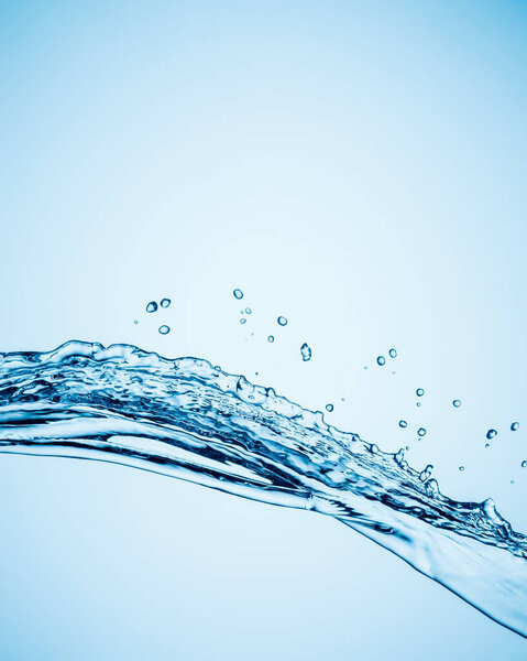 Splashes of pure water in the form of water with droplets on a blue gradient background. Copy space.