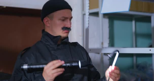Homme avec de fausses moustaches agit comme un voleur dans la salle de stockage — Video