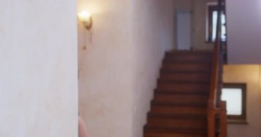 Şişman adam aceleyle odaya girer ve başını yana çevirir.