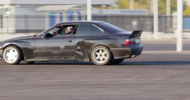 Rostov, RUSSIA - November 13 2021: Tuned drift car with racer drives in circles on marked track — стокове відео