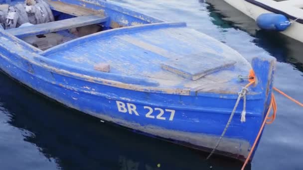 Bateau de pêche en bois rochers sur l'eau amarrée à quai dans le port — Video