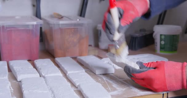 Homem prepara gesso tijolo molda pintura com escova pequena — Vídeo de Stock