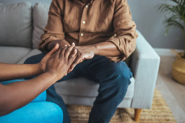 Professional care for elderly at nursing homes. Cropped shot of a female nurse hold her senior patient\'s hand. Close-up of home caregiver and senior woman holding hands