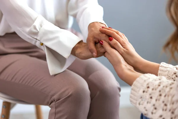 Psychologist hold hands of girl patient, close up. Teenage overcome break up, unrequited love. Abortion decision. Psychological therapy, survive personal crisis, individual counselling concept