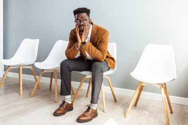 Young worried businessman waiting for job interview. I'm certain I have the right skills for this job. Man waiting or job interview