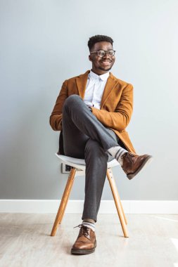 african american man sitting on chair in studio