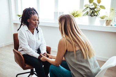 Psychology, depression. Sad, suffering asian young woman, consulting with psychologist, psychiatrist while patient counseling mental problem with doctor at clinic. Encouraging, therapy, health care