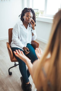 Psychology, depression. Sad, suffering asian young woman, consulting with psychologist, psychiatrist while patient counseling mental problem with doctor at clinic. Encouraging, therapy, health care