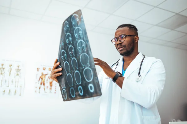 Medical Brain concept. Doctor check up x-ray film of the brain patient by mri scan at hospital. Doctor give advice to patient about MRI (Xray) brain Scans. MRI digital x-ray of brain with radiologist doctor