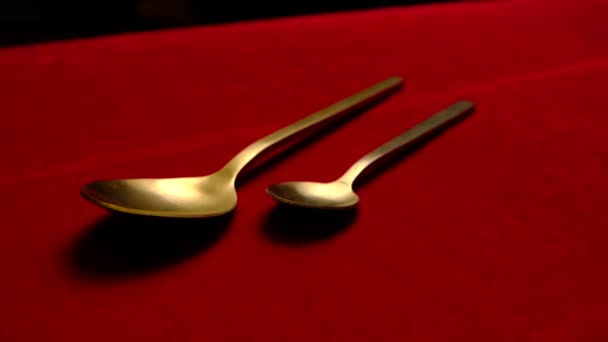 Golden spoon isolated on red background. — Stock Video