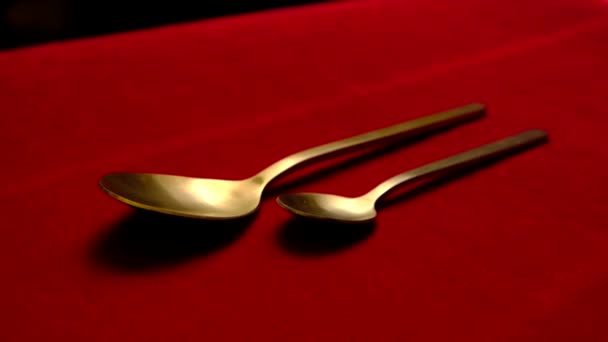 Golden spoon isolated on red background. — Stock Video