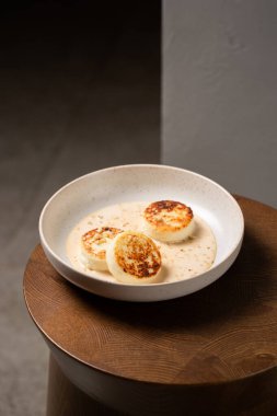 Süzme peynirli krep ya da karamel soslu ve fındıklı şurup. Karamsar ve karamsar sağlıklı kahvaltıyı hesaba kat. Makro ve seçici odak resmi.