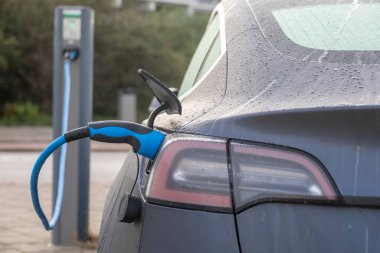 Tesla elektrikli araba Hollanda 'daki şarj istasyonundaki pilleri şarj ediyor.