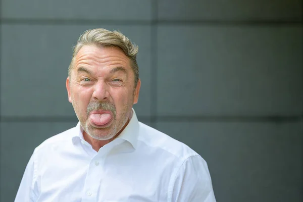 Childish Senior Man Sticking Out His Tongue Camera Rude Gesture — Stock Photo, Image