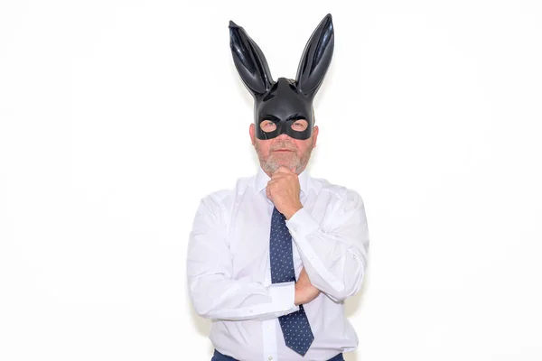 Businessman Wearing Bunny Mask Looking Pensively Camera Hand Chin Easter — стоковое фото