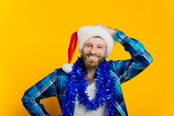 Portrait Young Adult Guy 30S Tinsel Who Straightens Santa Hat — Fotografia de Stock