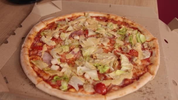 Pizza op open papieren doos achtergrond, bovenaanzicht. Pizza met vlees, kool, kersen — Stockvideo