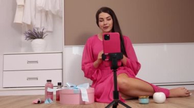 Genç, güzel kız blogcu blog için hediye paketini açtığı bir video yazıyor.