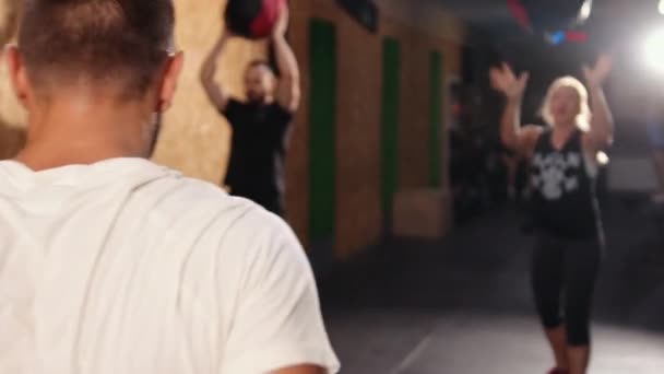 Mooie Europese mannen gooien cross fit bal. Man in sportkleding tijdens de cirkel — Stockvideo