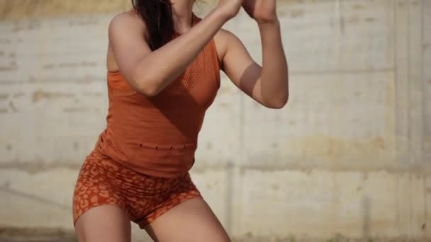 Copy space. Deep squat. Side view of young beautiful woman in sportswear — Stock Video