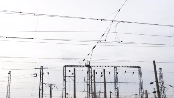 Power electricity wire trains against sky. Close up of railway electrification — Stockvideo