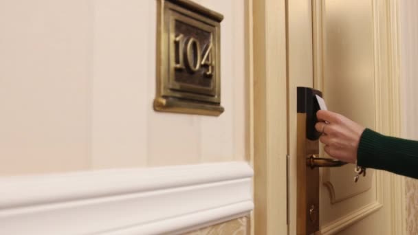 Modern hotel room. Young lady or woman used key card for access digital door — Video Stock