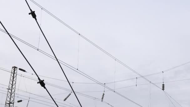 Power electricity wire trains against sky. Close up of railway electrification — Stockvideo