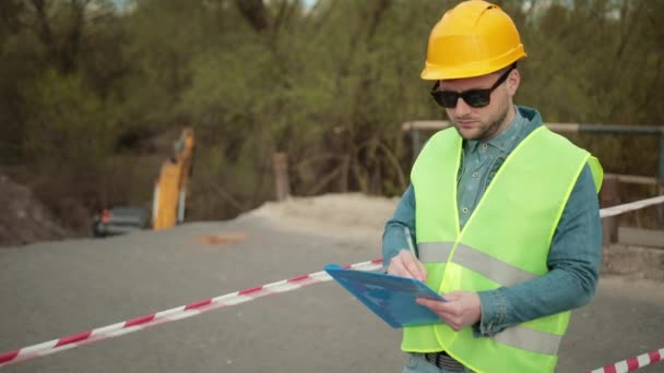 Reconstructed construction, renovation road surface. Industrial engineer in hat — Stock Video
