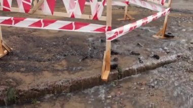 Kanalizasyon, su borusu. Tehlike sınırı yolda su sızıntısına yakın. Yol fışkıran su