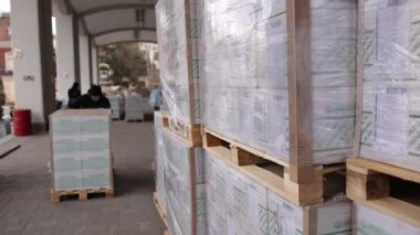 Forklift yükleyici kargo kutuları depoluyor. İşçi çatalı palet istifleyici