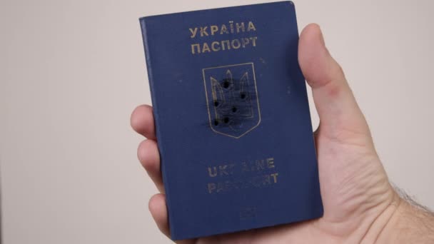 Holes in shot Ukrainian passport. Concept of occupation of the country, war — Stock Video