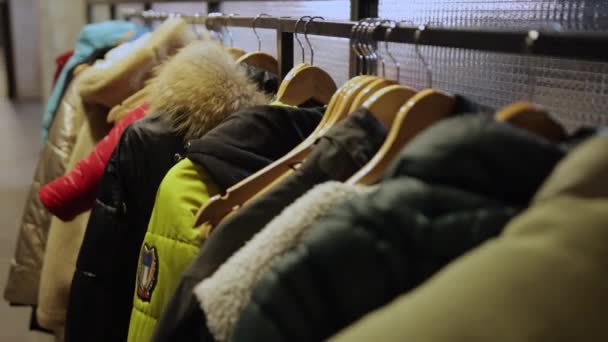 Wardrobe. Human jackets are hanging. A concept of displaced people, refugees — Stock Video