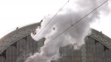 Steam pipe of steam locomotive of railway. Factory pipe of steam locomotive. A plume of white smoke goes up, waste into the atmosphere, environmental hazards, environmental storage